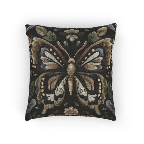 A square decorative pillow featuring an intricately detailed butterfly design in olive green, sage, and cream colors against a black background. The butterfly is surrounded by botanical elements with symmetrical floral patterns.